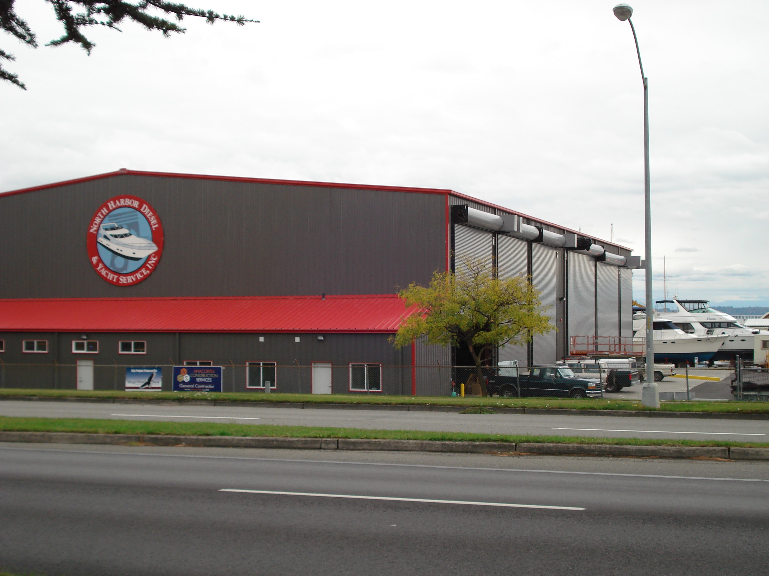 North Harbor Diesel & Yacht Service main facility building on Commercial Avenue in Anacortes, WA — 22,000 sq ft indoor boatyard with large roll-up doors and NHD logo on exterior
