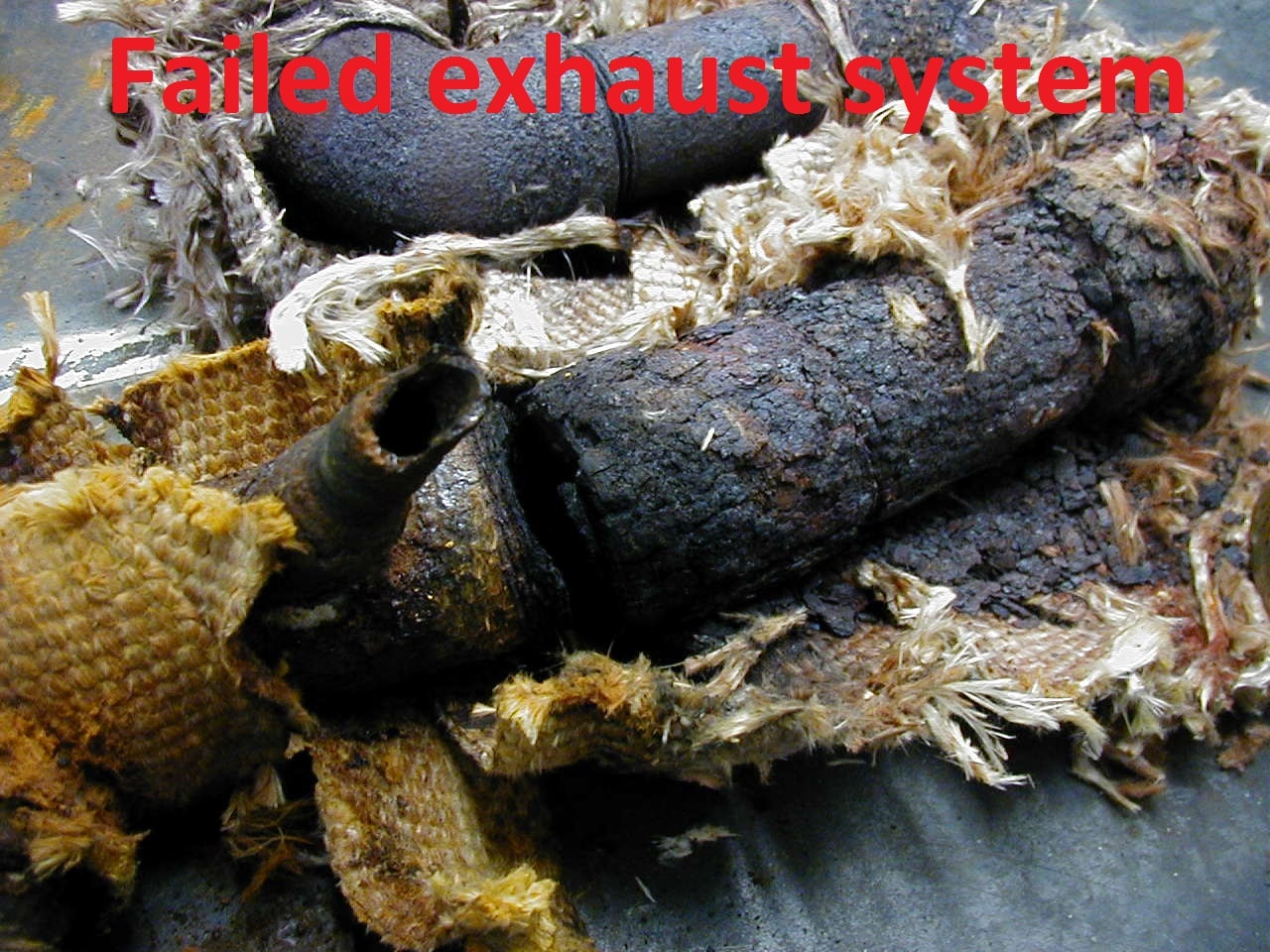 Failed marine exhaust system showing severely corroded and deteriorated pipes and insulation