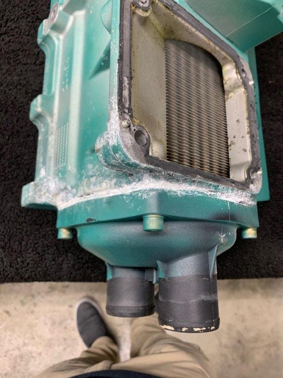 Fouled Volvo Penta heat exchanger end cap packed with marine growth and debris