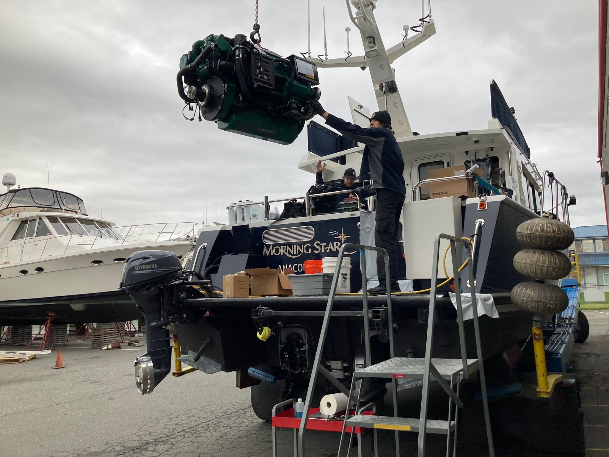Volvo Penta engine being craned into Morning Star vessel at NHD boatyard