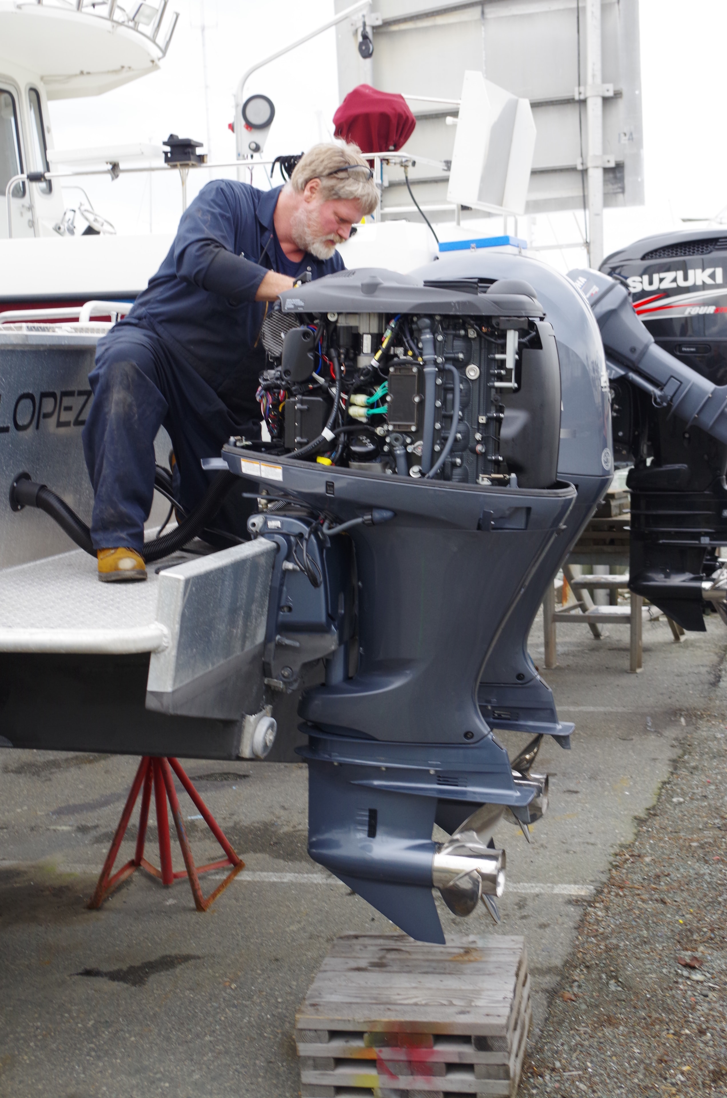 NHD technician servicing a Yamaha outboard motor in the boatyard