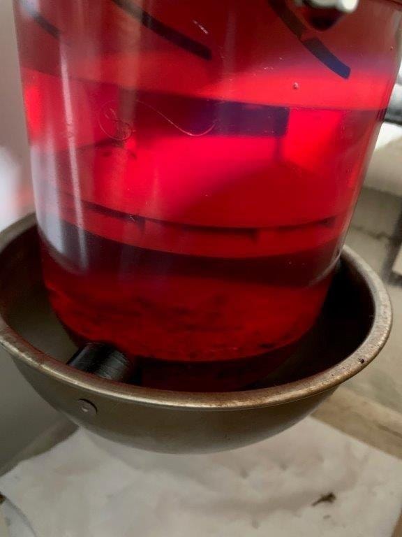 Racor fuel filter bowl showing red diesel fuel during filter service