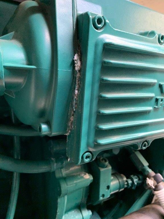 Cracked Volvo Penta engine block showing corrosion damage at cylinder head seam
