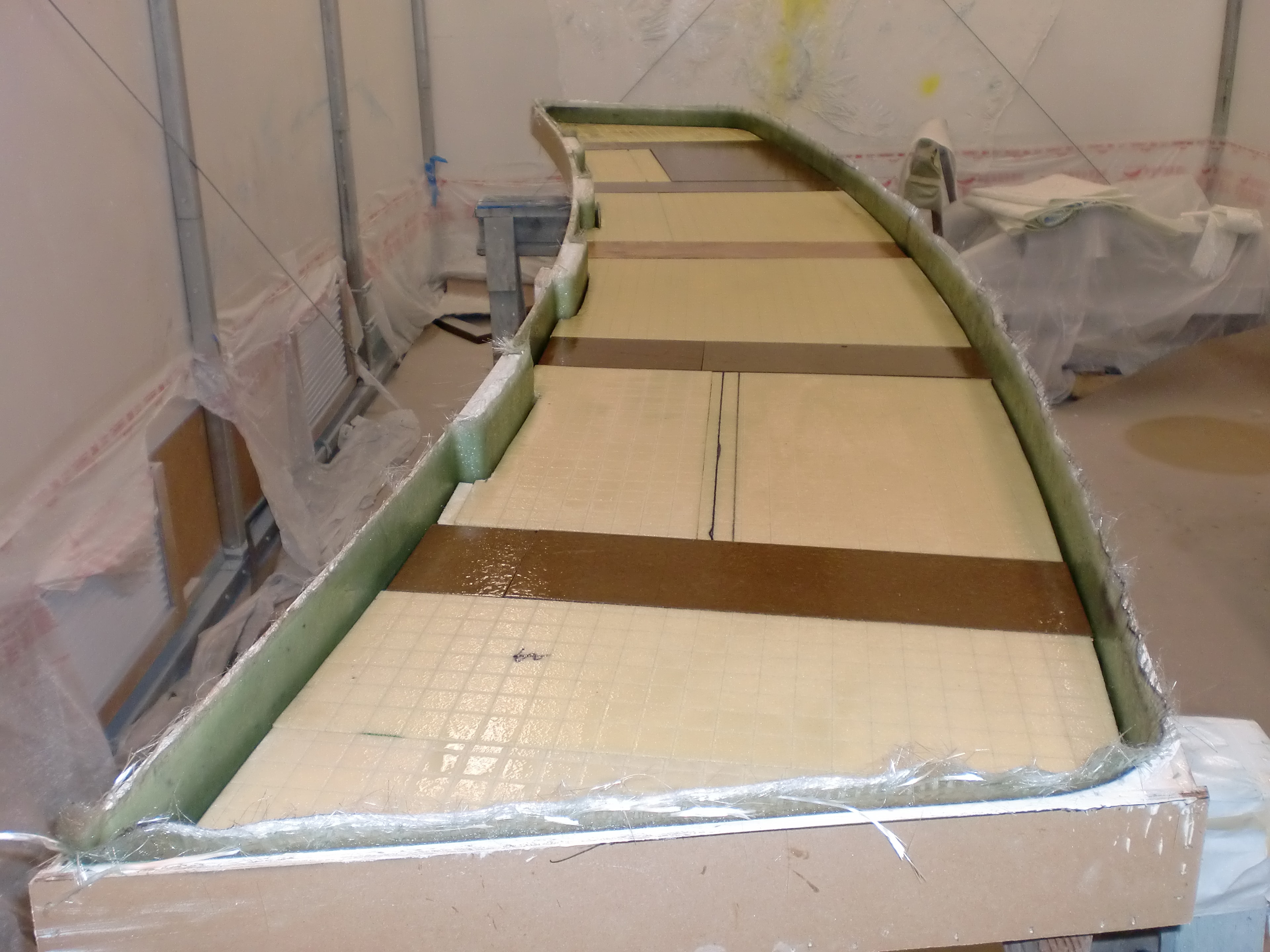 Fiberglass deck core fabrication in progress inside paint tent